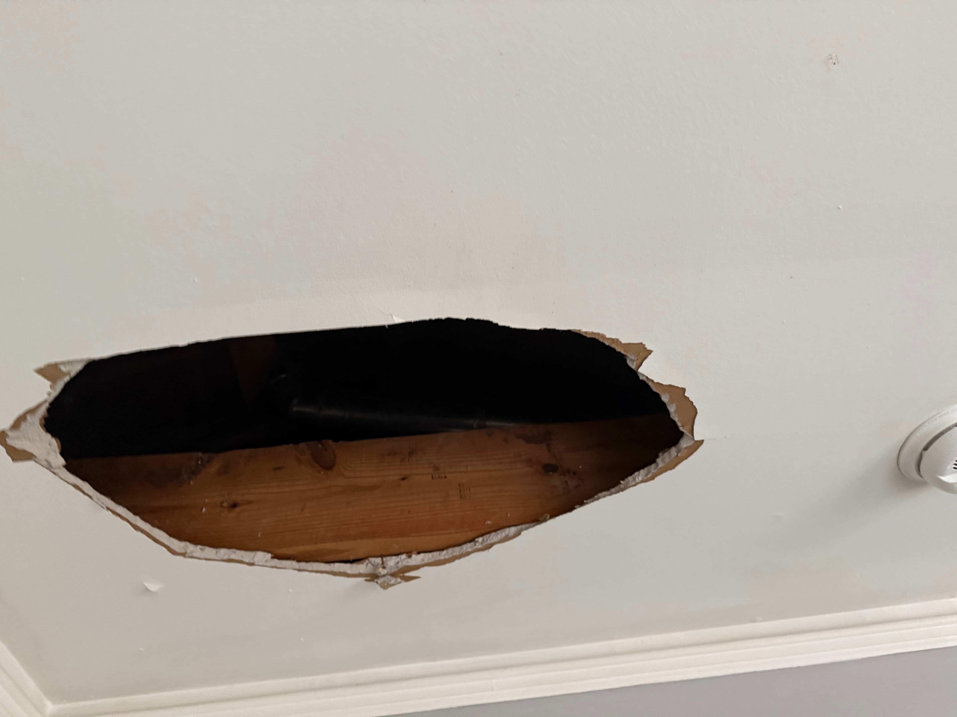 Hole burned through the ceiling from the water heater explosion